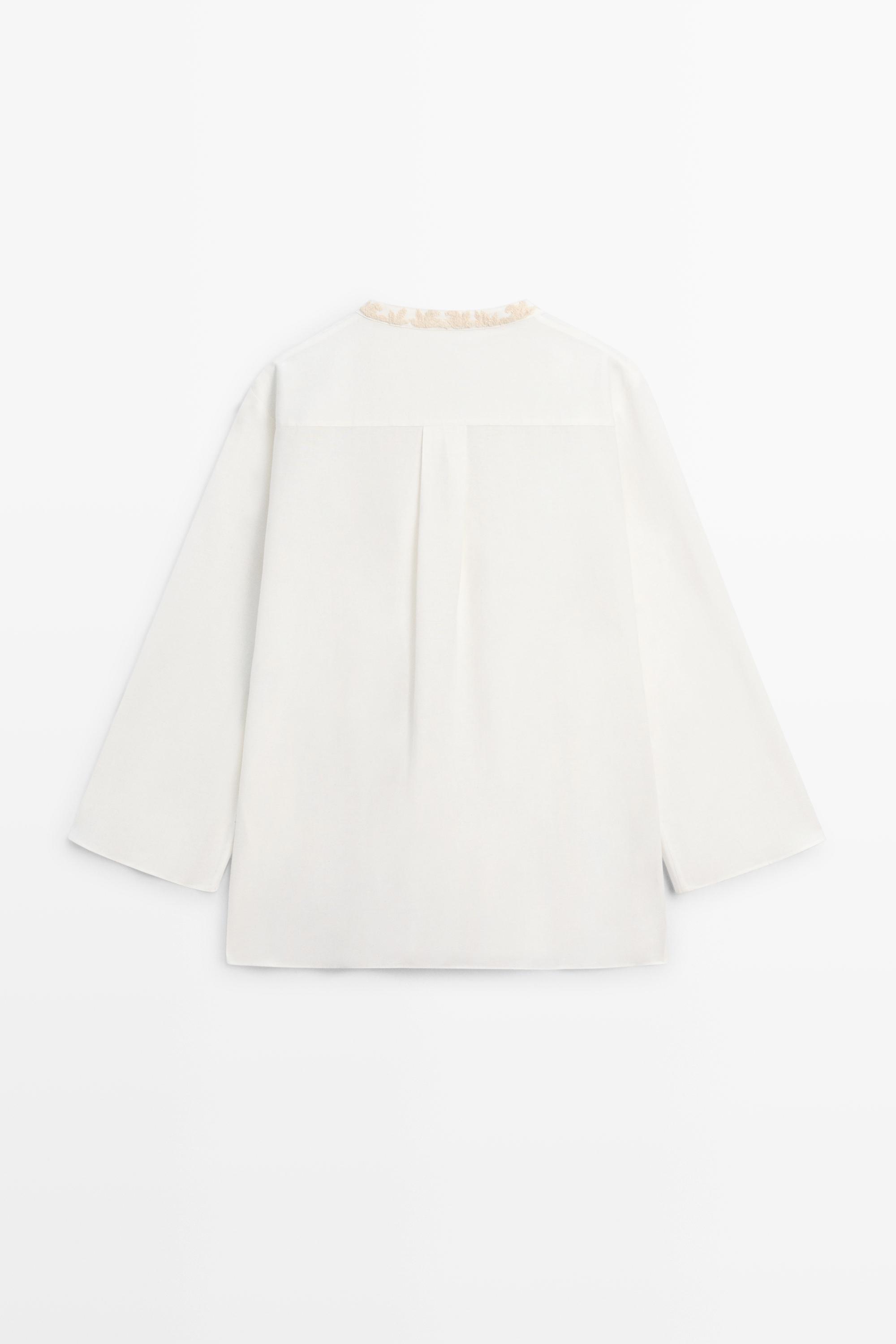 Flowing oversize blouse with stand collar and embroidery